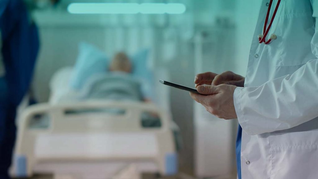 médico-com-tablet-e-paciente-internado-em-um-quarto-de-hospital